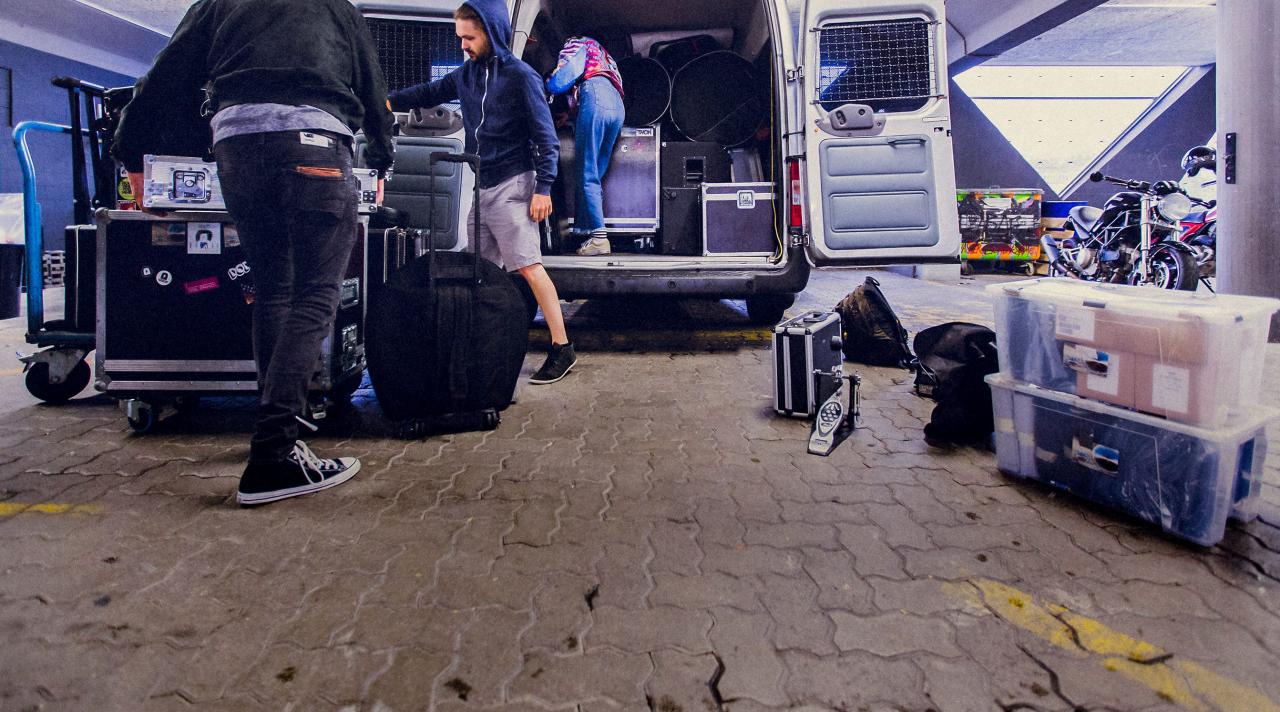 Junge Musiker beladen einen Transporter mit Musikintrumenten